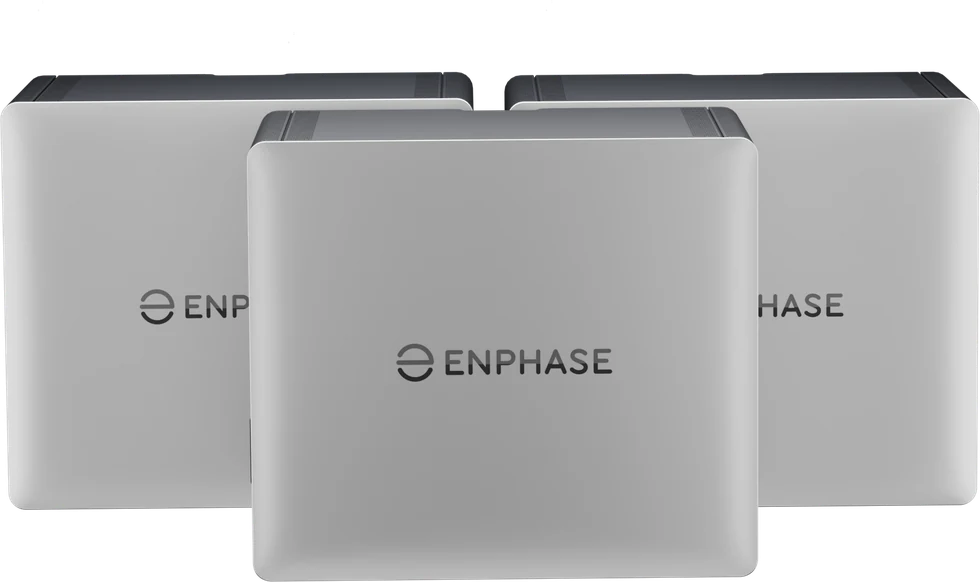 Three Enphase IQ Battery units, front and three quarter view, in light grey with a dark top panel.